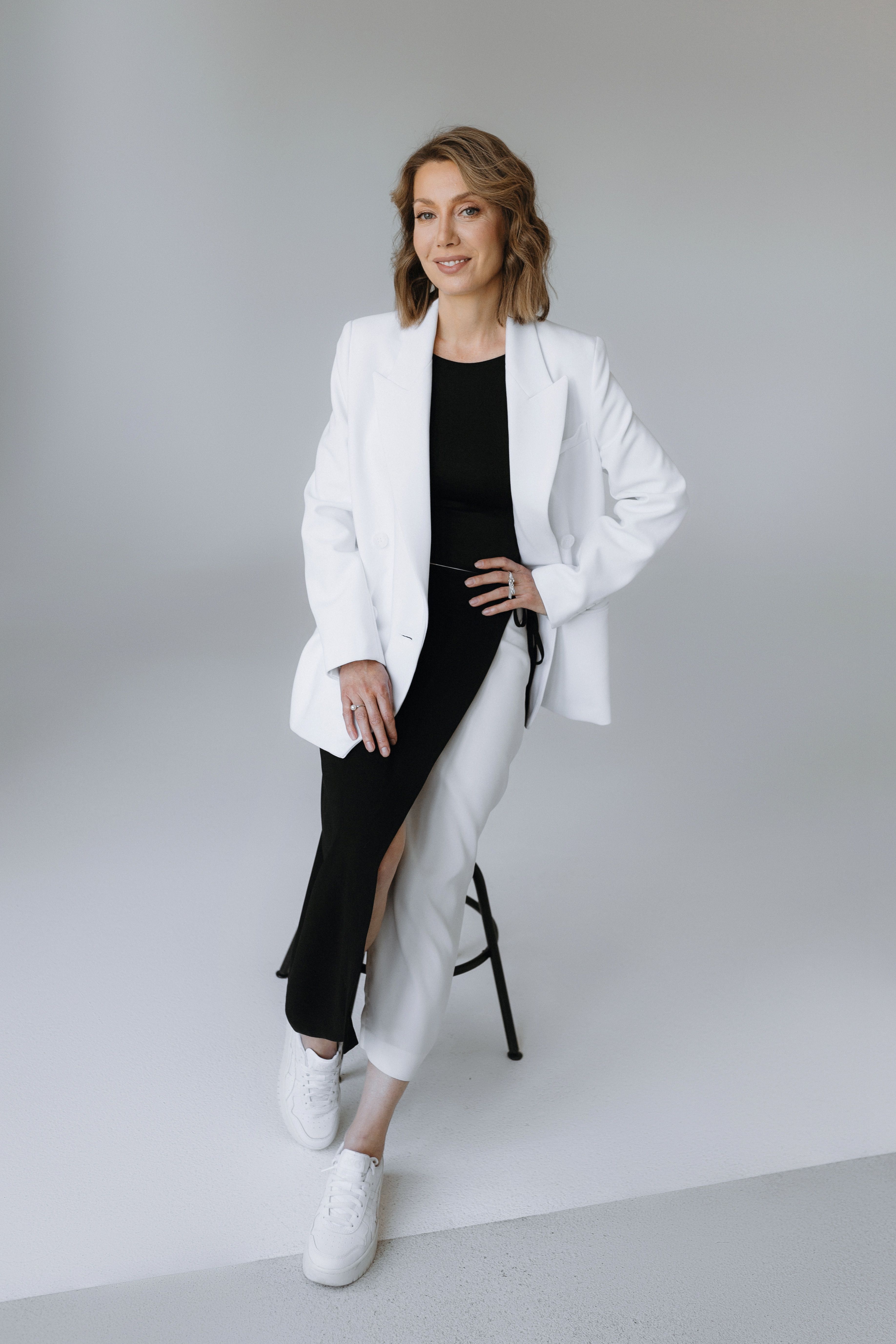 Smiling Woman in White Suit · Free Stock Photo