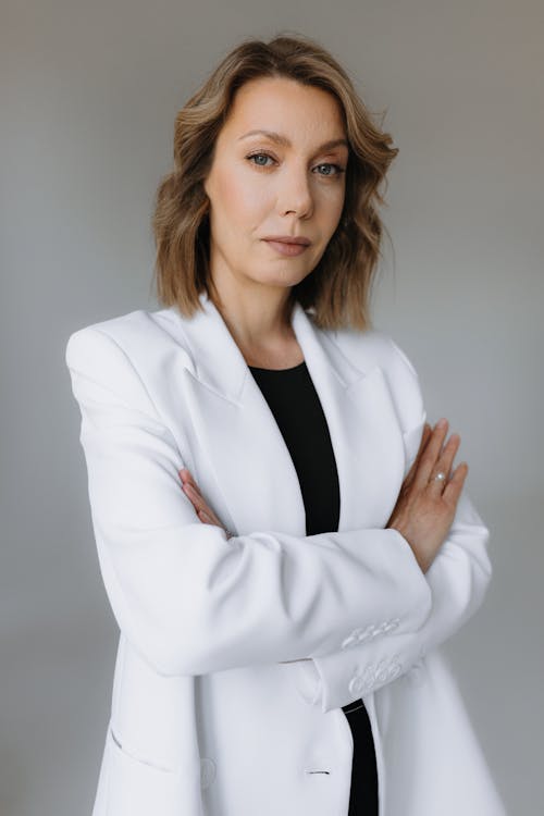 A woman in a white jacket and black shirt