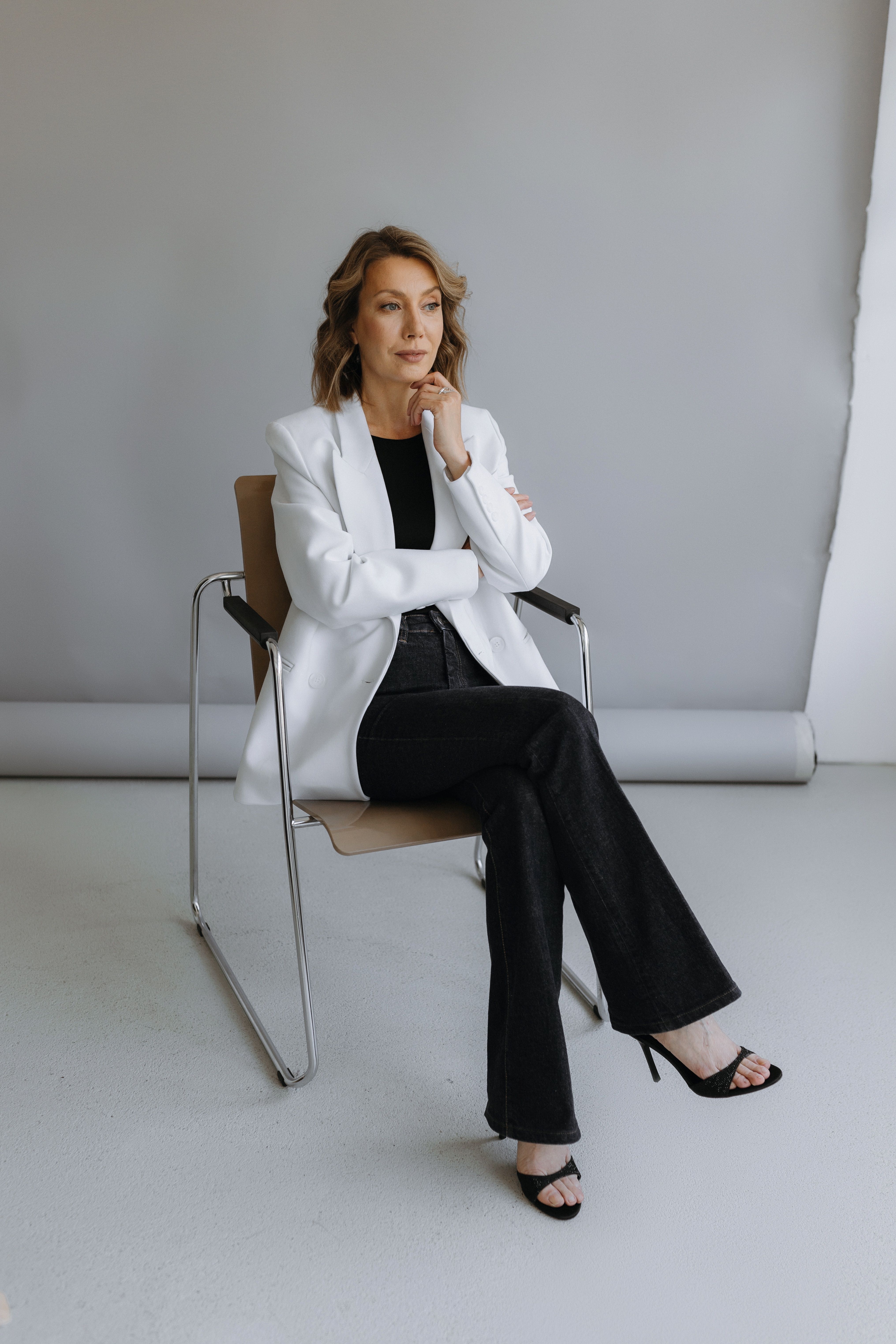 Woman Sitting in White Suit · Free Stock Photo
