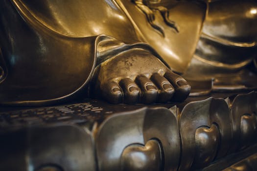 Detailed close-up of a golden Buddha statue's foot, highlighting intricate design and craftsmanship in Shanghai.
