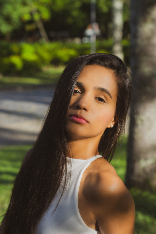 Stylish Woman in Sunlit Urban Park Setting · Free Stock Photo