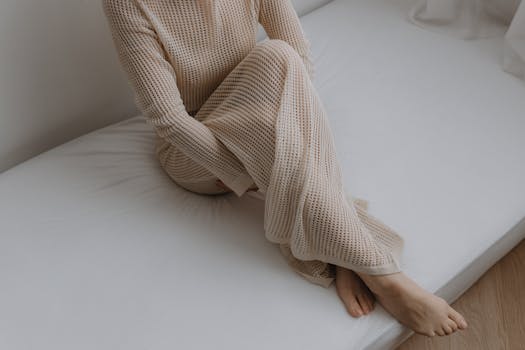 Portrait of a woman in a beige dress with minimalist style and serene pose.