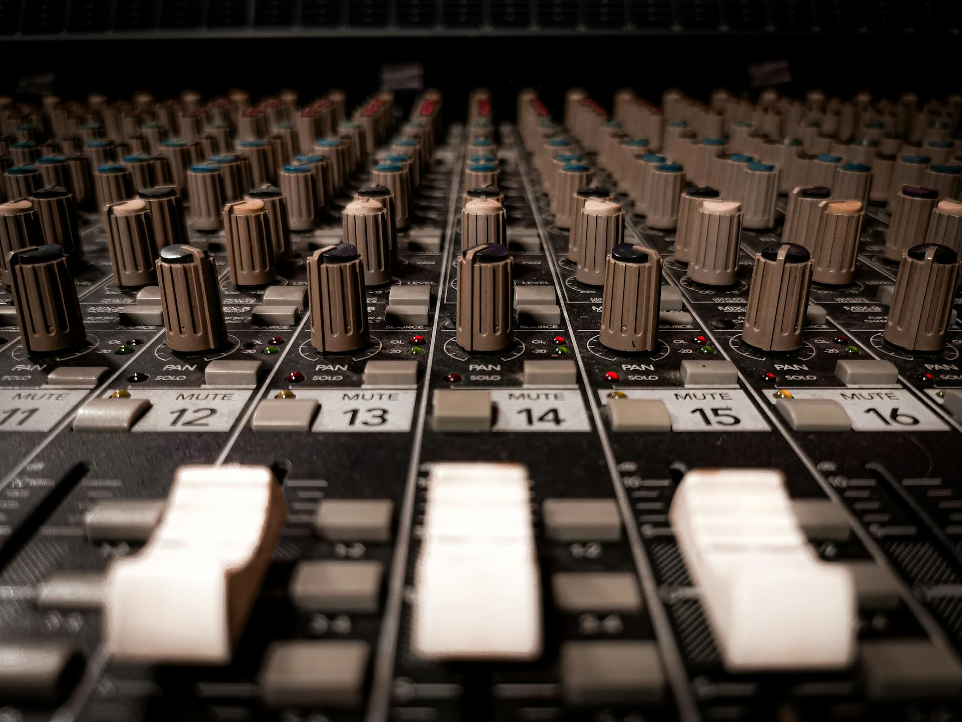 Detailed close-up of a professional sound mixer console in Phnom Penh studio.