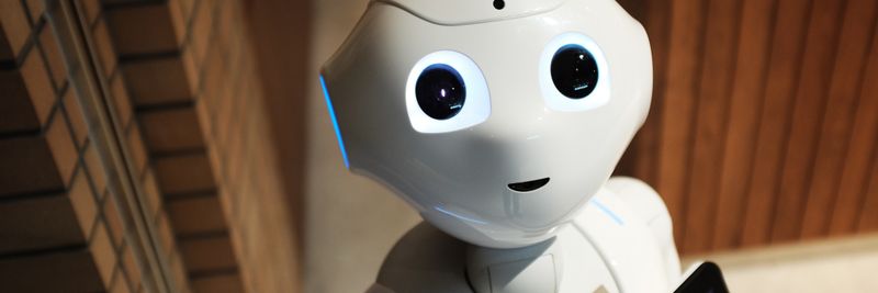 A futuristic humanoid robot in an indoor Tokyo setting, showcasing modern technology.