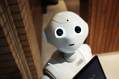 A white humanoid robot at a demonstration