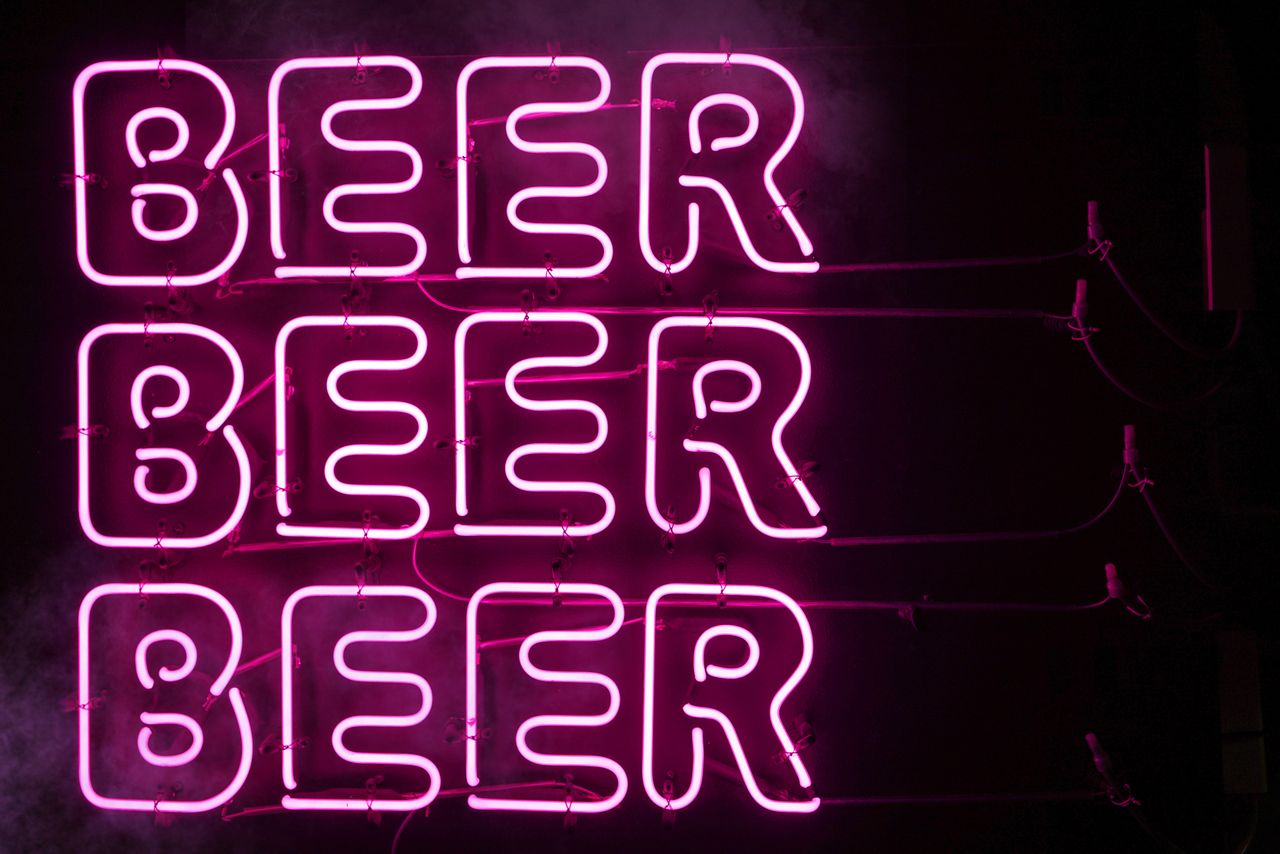 bright pink neon sign displaying the word beer in tokyo japan at night