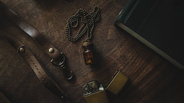 Brown Vial Pendant Necklace On Brown Wooden Surface