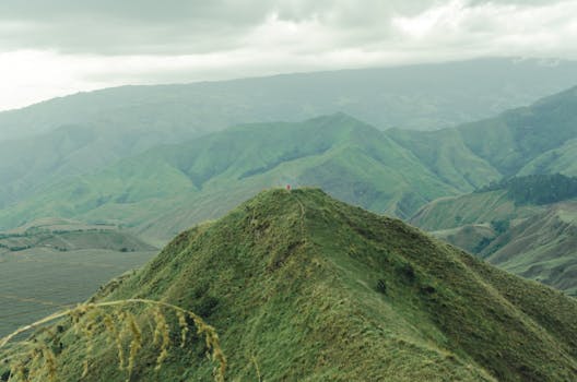 Stunning aerial view of verdant mountains in Northern Mindanao, Philippines, showcasing natural beauty and tranquility.
