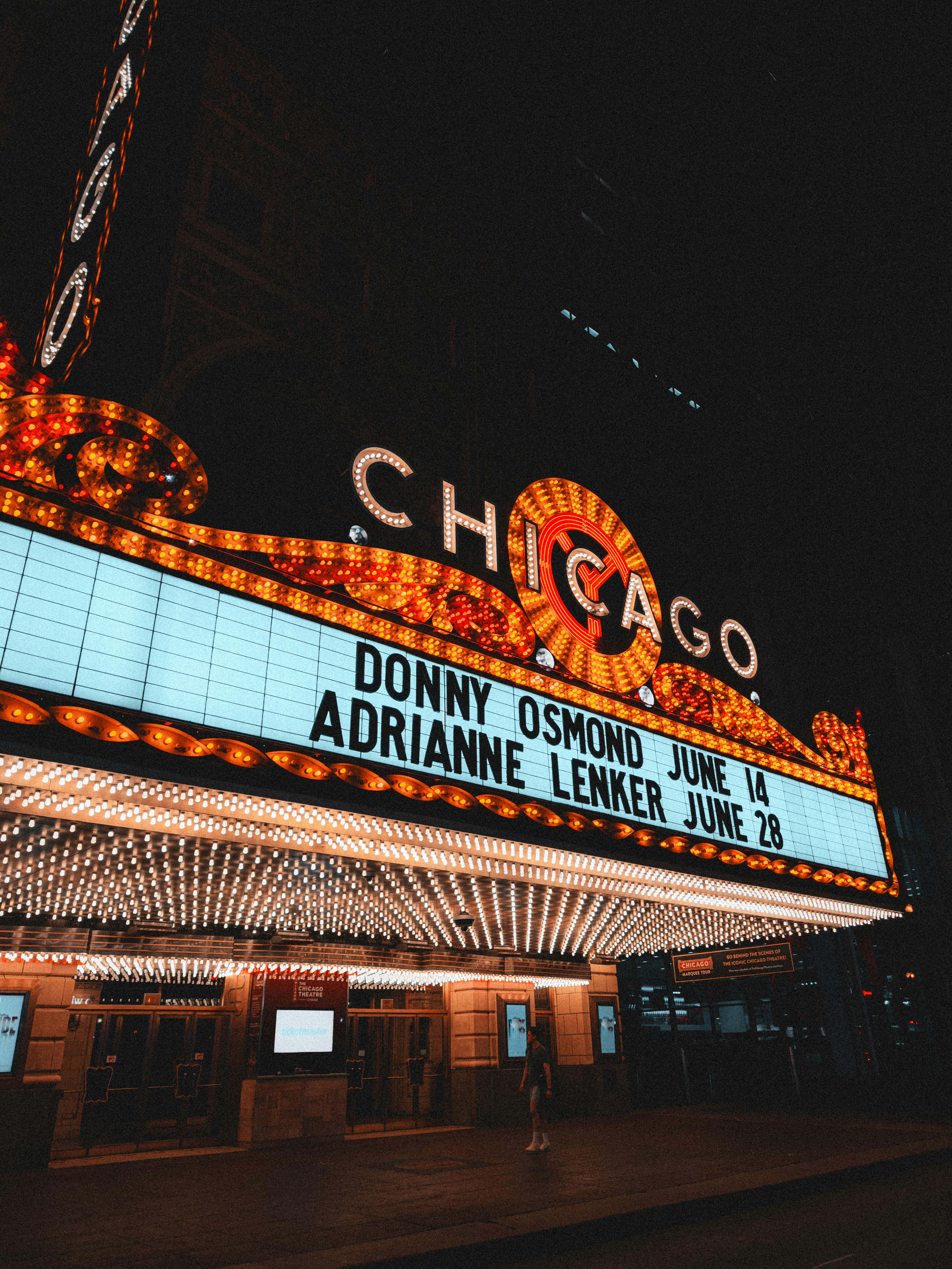 Free The illuminated marquee of the Chicago Theatre shines bright showcasing upcoming events. Stock Photo