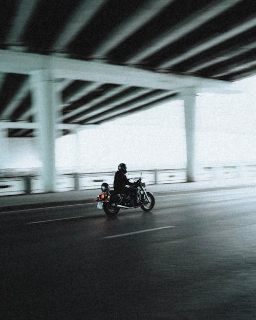 Man Riding Motorcycle on Road