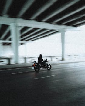 A lone motorcyclist speeds under a city overpass in Moscow, Russia.
