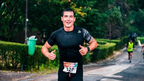 Photo of a Man Running Outdoors