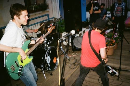 Free Live indie band performing energetically on an outdoor stage. Stock Photo