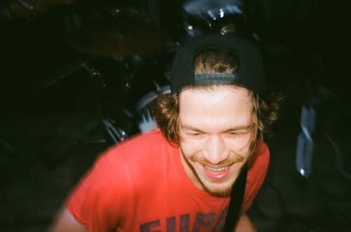 Close-Up Photo of a Smiling Man in Red Shirt