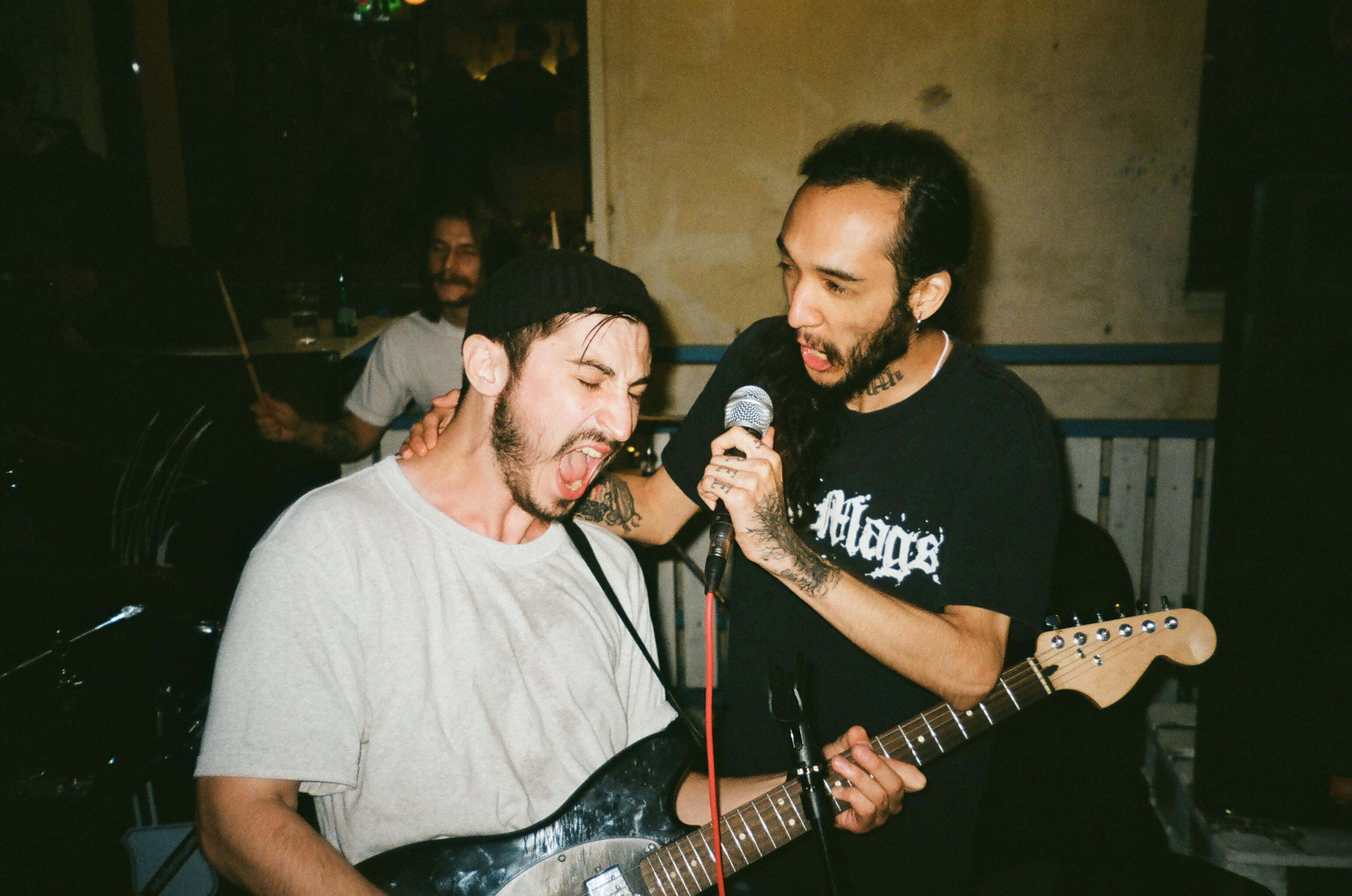 Photo of Two Men Singing