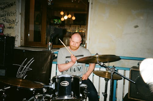 Man in Gray T-shirt Playing Drums