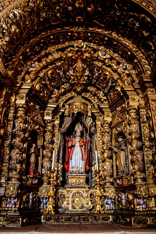 Free Intricately decorated religious altar at a church in Faro, Portugal showcases detailed sculptures and golden elements. Stock Photo