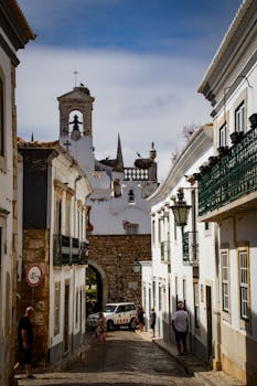 Explore the picturesque cobblestone streets of Faro, Portugal, showcasing stunning architecture.