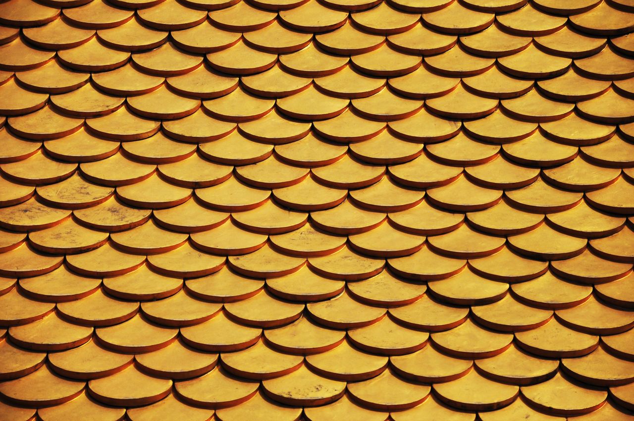 close up of a golden scaled roof pattern ideal for design backgrounds