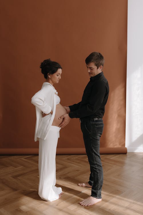 A man and woman standing in front of a wall