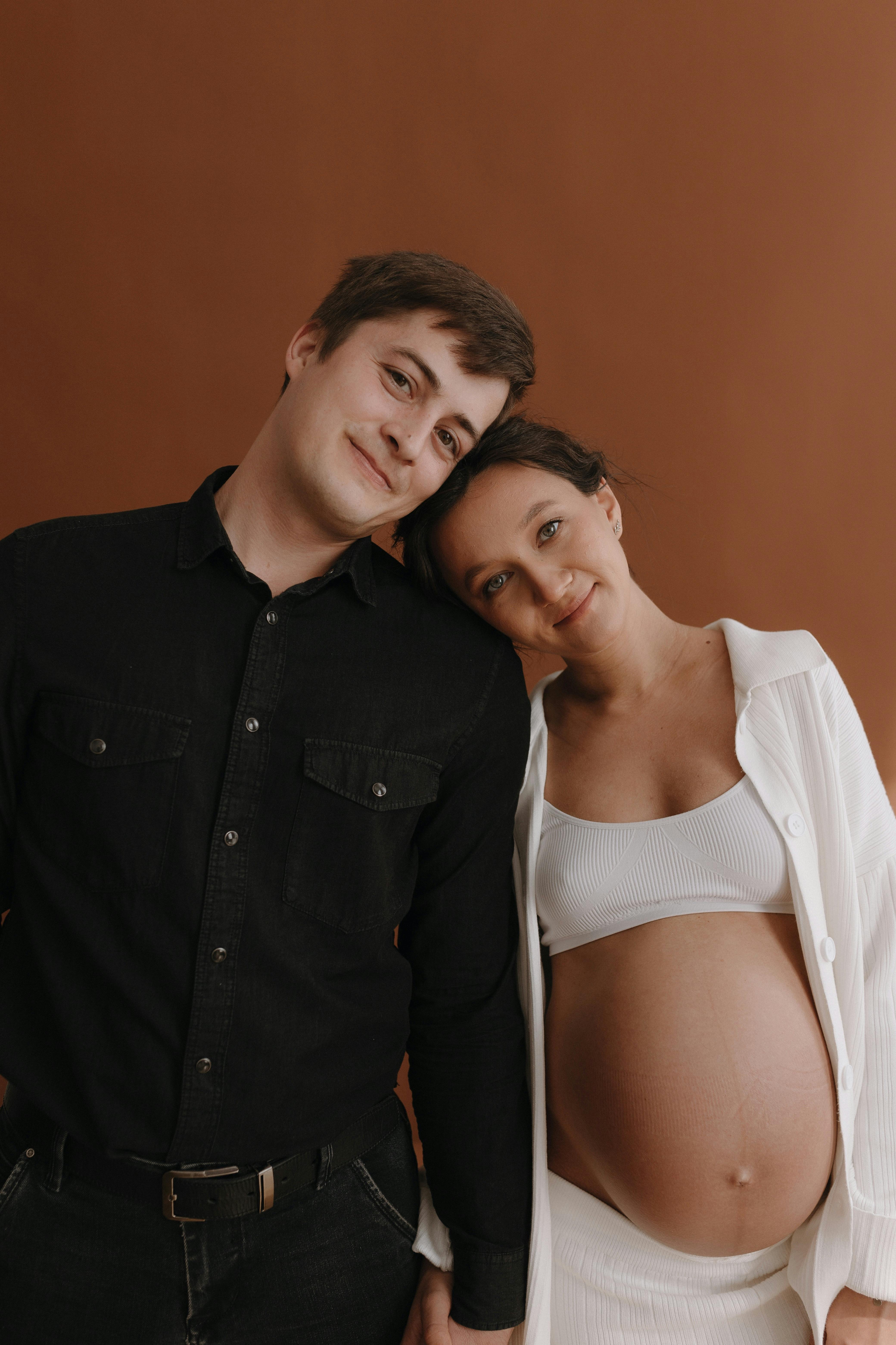 portrait of smiling man and pregnant woman