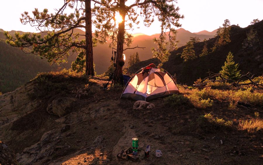 Tent in a forested mountain campsite