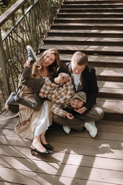 A family is sitting on the stairs in the woods