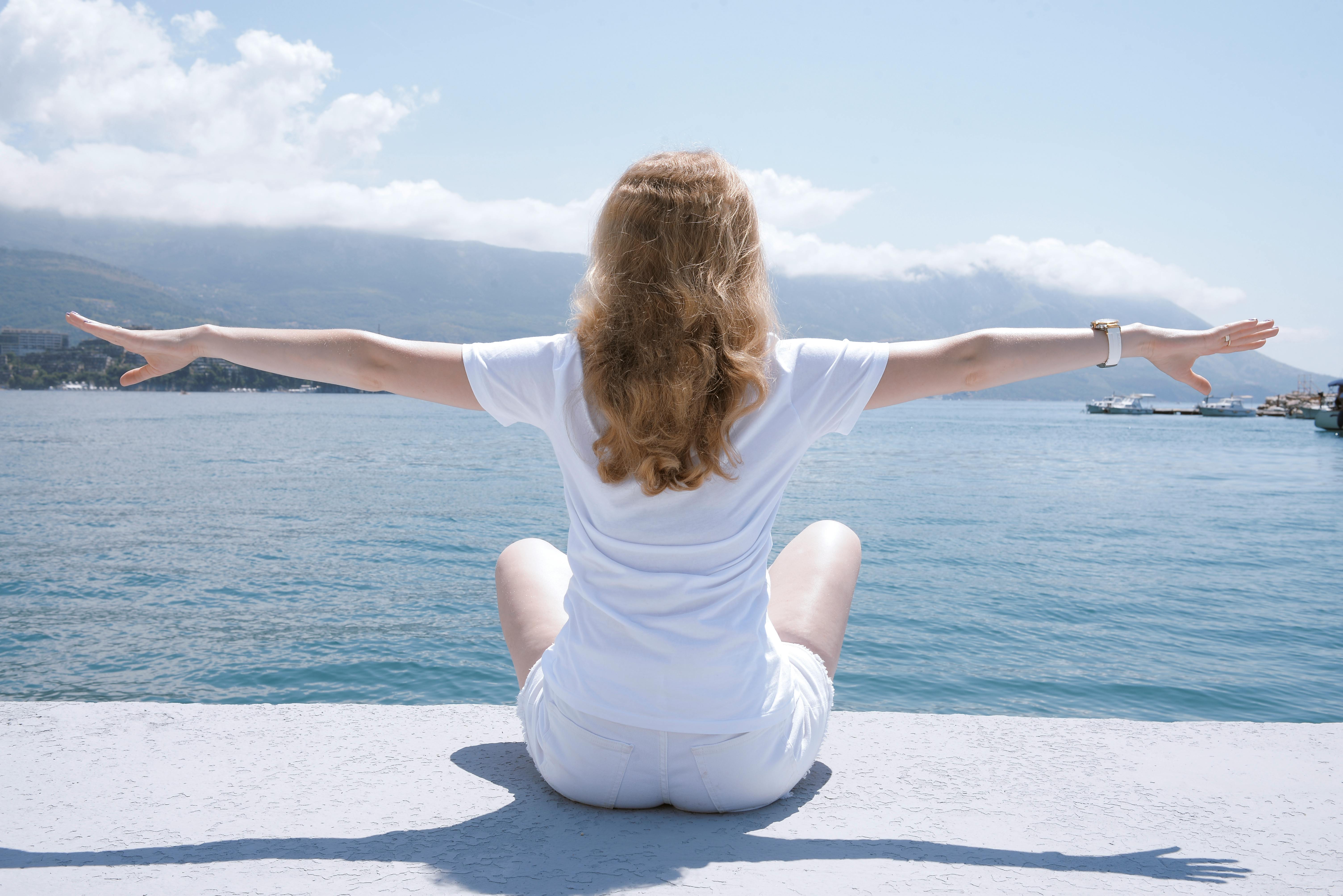 woman meditating near the sea