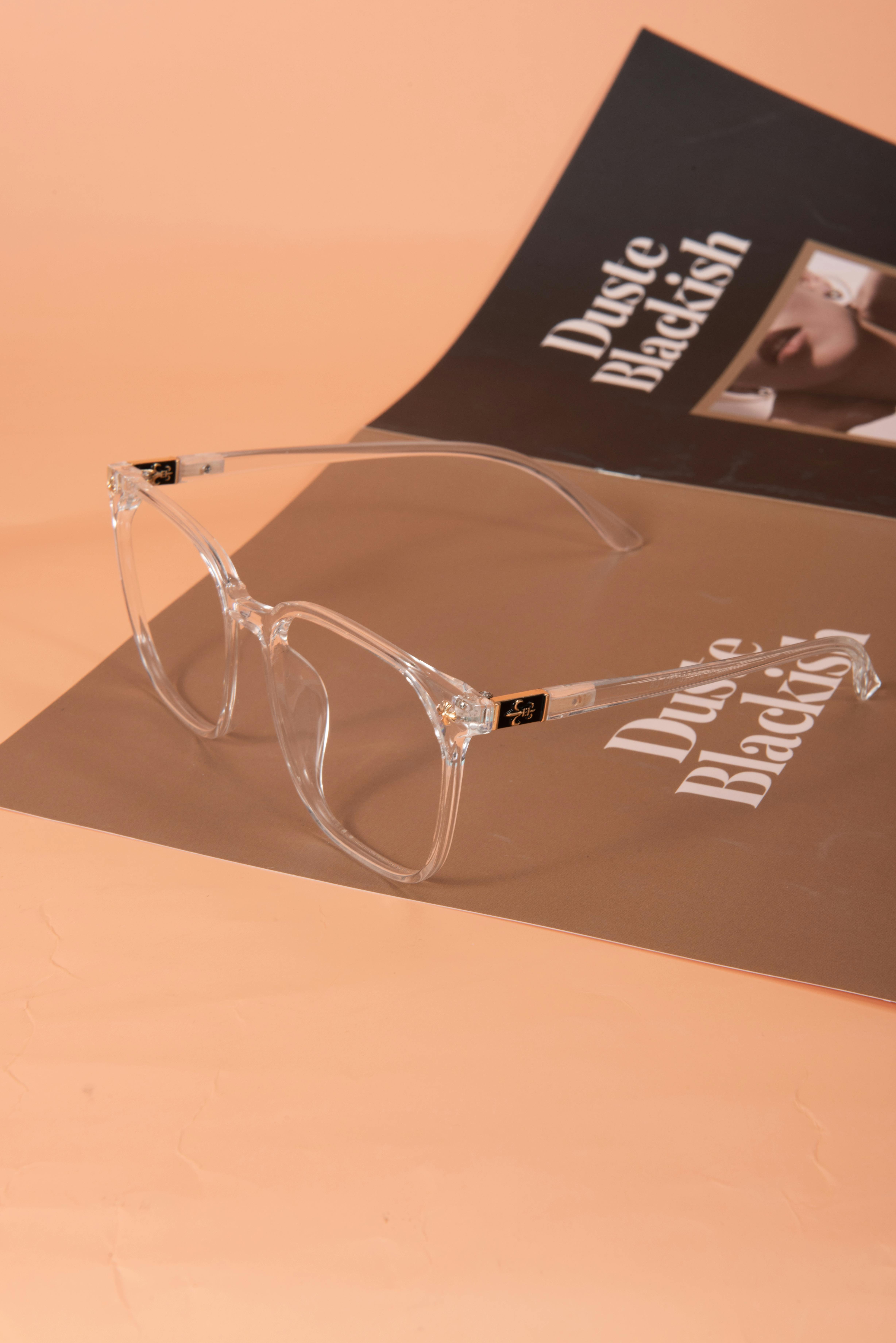 Clear eyeglasses on a Dusty Blackish magazine cover, elegant and fashionable.