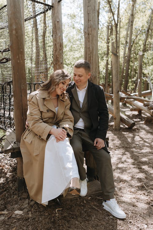 A couple sitting on a bench in the woods