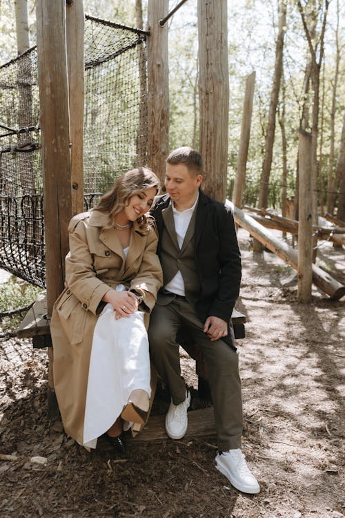 A couple sitting on a log in the woods