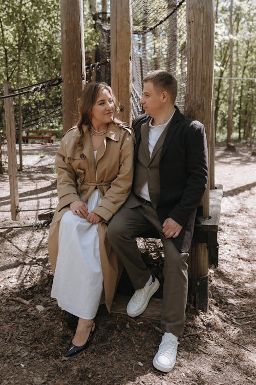 A couple sitting on a bench in the woods