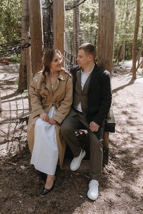 A couple sitting on a bench in the woods