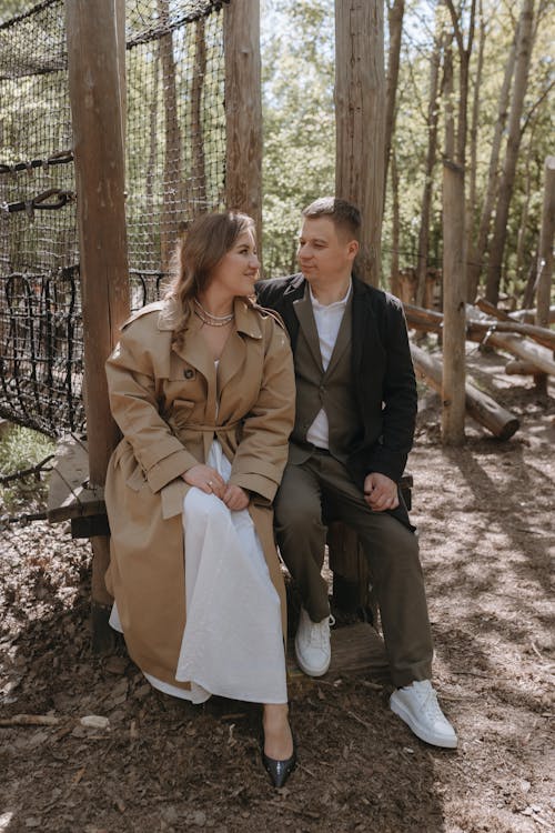 A couple sitting on a bench in the woods