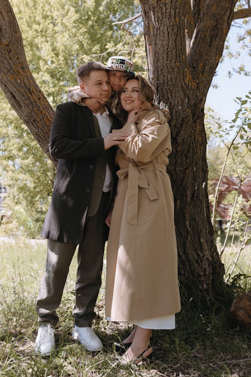 A couple in a trench coat hugging each other