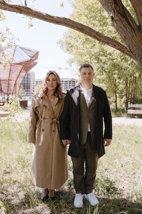 A man and woman standing in front of a tree