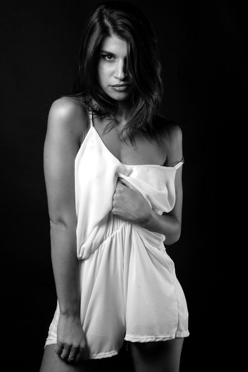 Free Chic studio portrait of a woman in black and white, showcasing elegance and style. Stock Photo