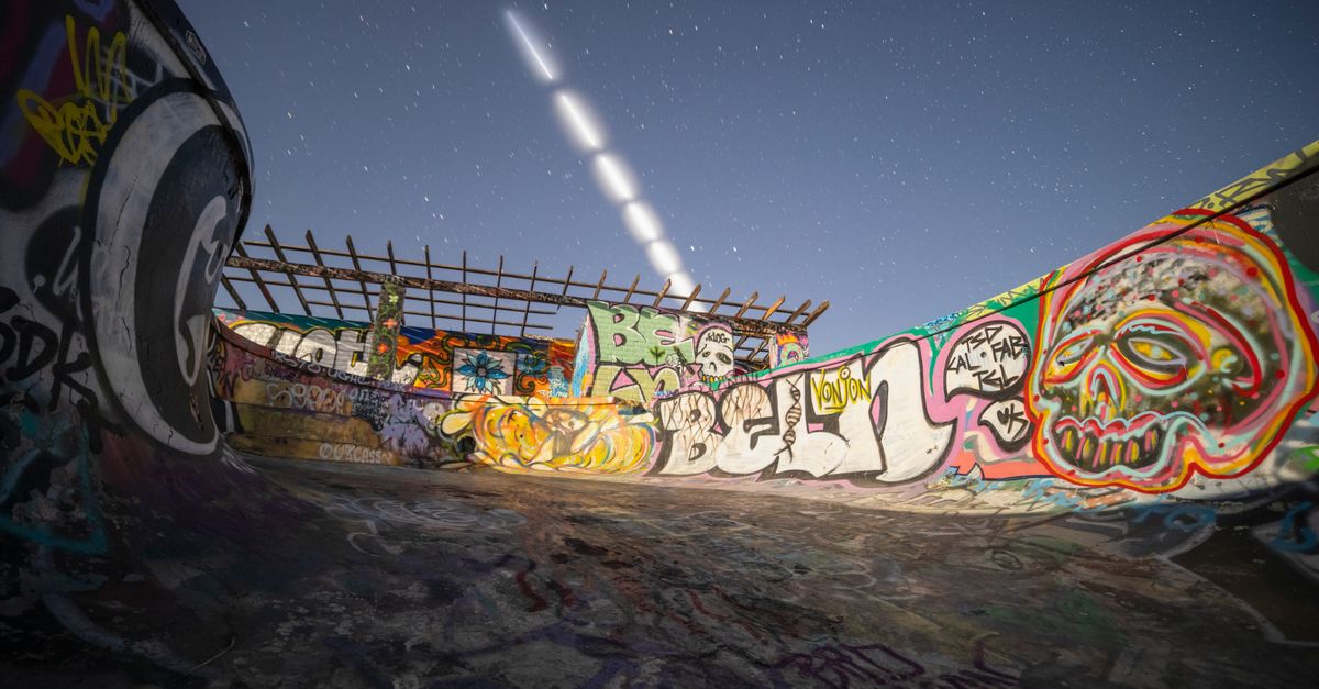 SpaceX sets dual launch day with Northrop Grumman servicing satellite and Starlink mission Dynamic view of a graffiti-covered skate park under a starry night sky with light trails.