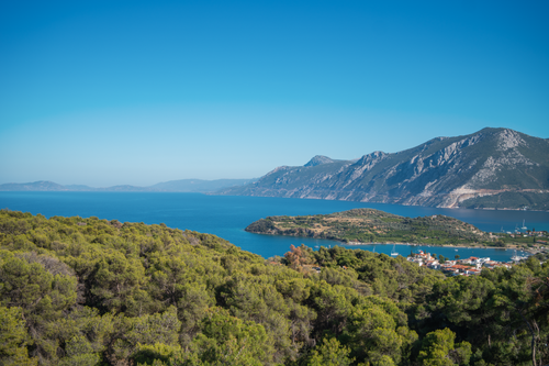 Free Panoramic view of lush coastline and mountains meeting the sea in Greece. Stock Photo