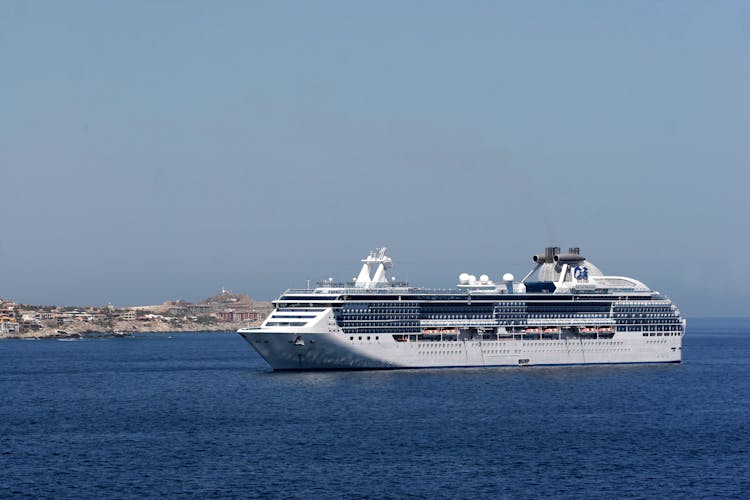 White Cruise Ship Sailing On Sea