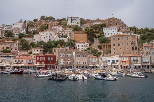 Free Charming waterfront view of a Greek town with boats and traditional houses. Stock Photo