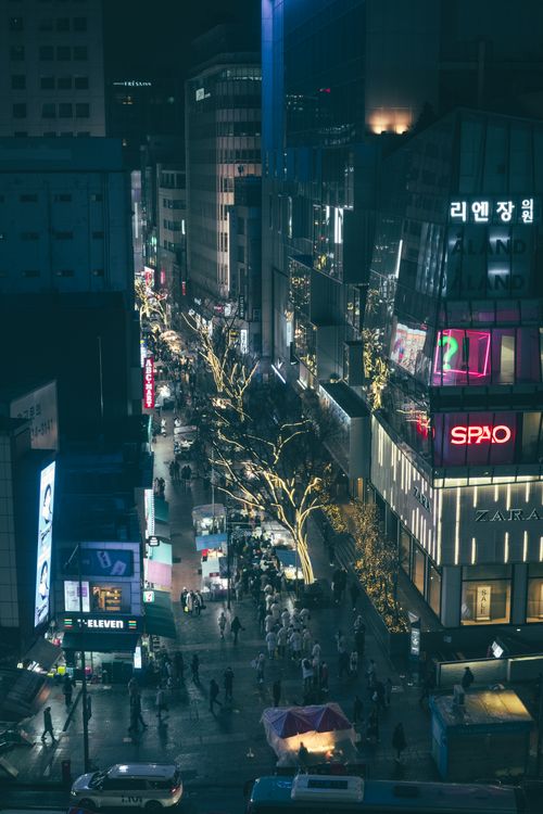 Free A lively aerial view of a bustling street in Seoul at night, showcasing bright city lights and a vibrant atmosphere. Stock Photo