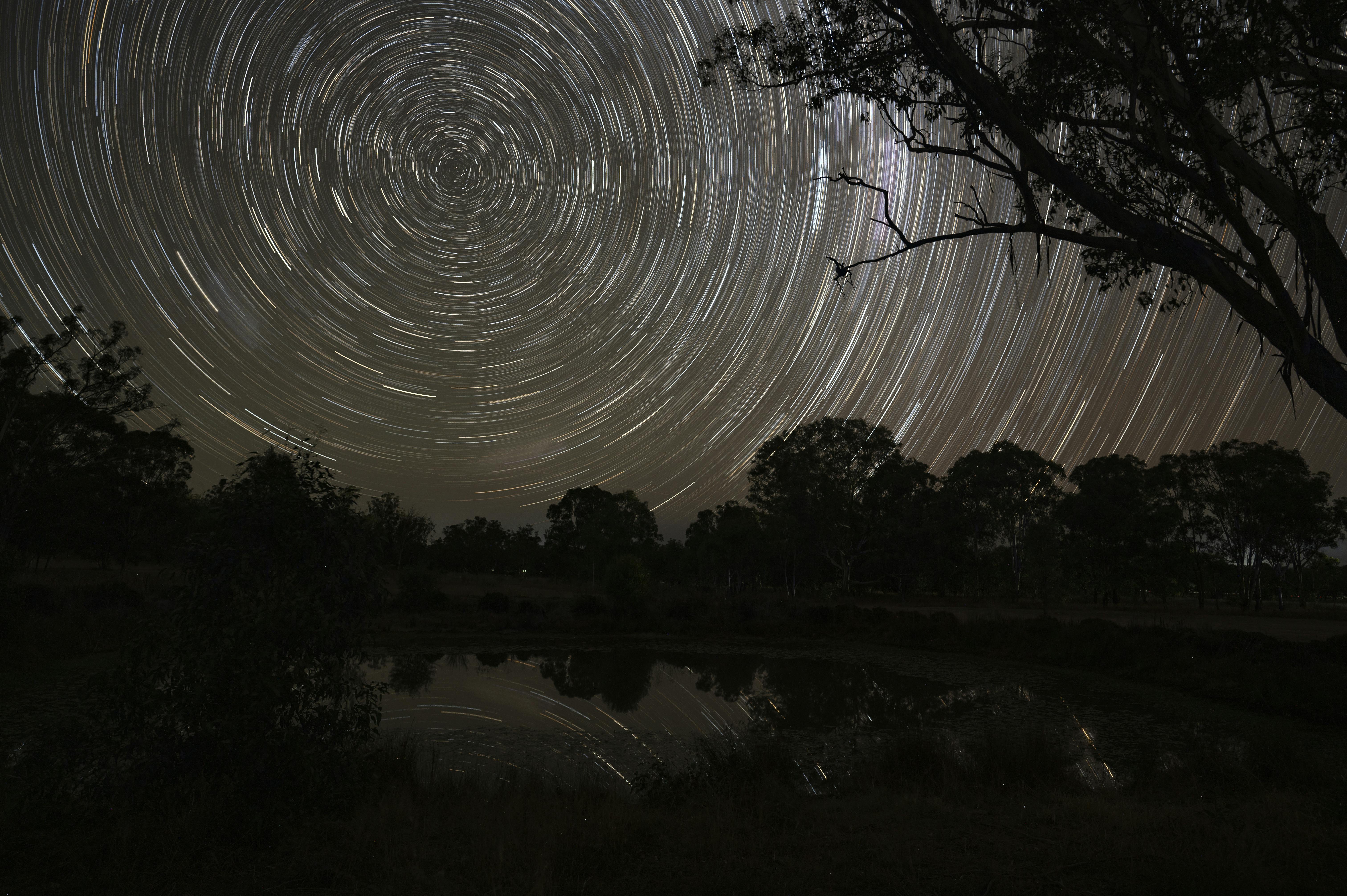 Stunning long exposure of star trails over a lake at Rodgers Creek, Australia.