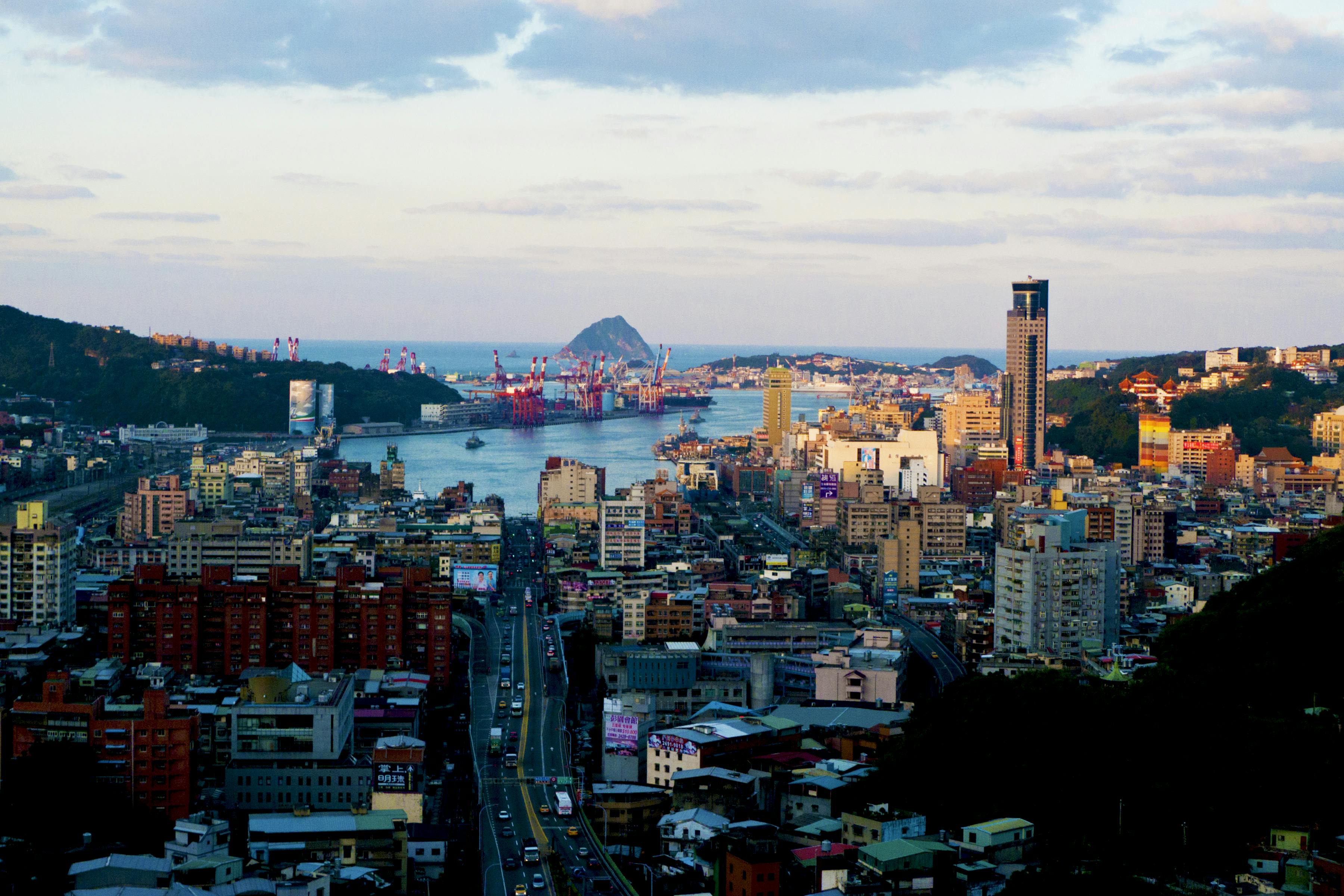 Panoramic view of Keelung cityscape with harbor and skyline under clear skies, Taiwan.