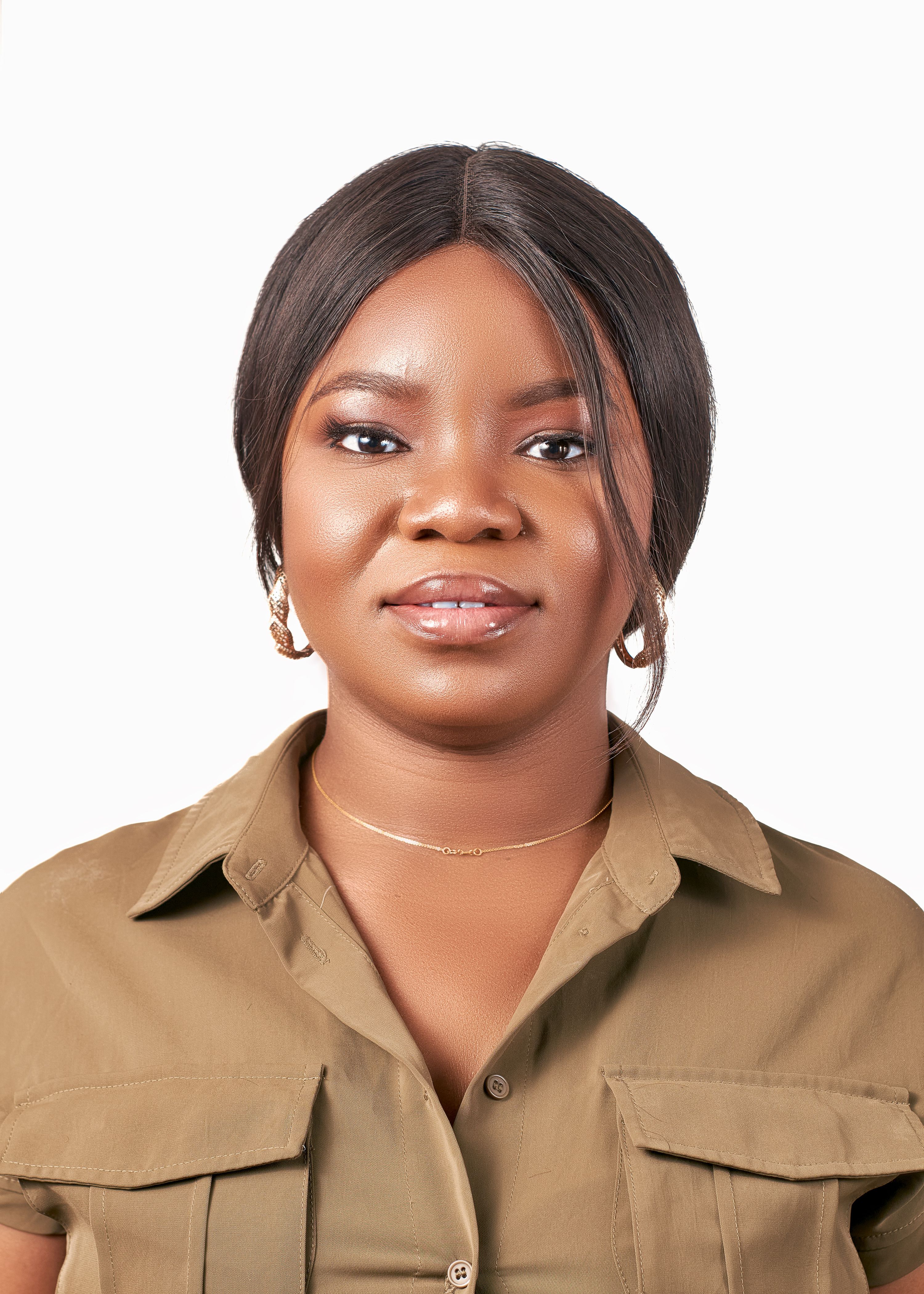 Portrait of a smiling black woman in a studio setting with a clean white background.