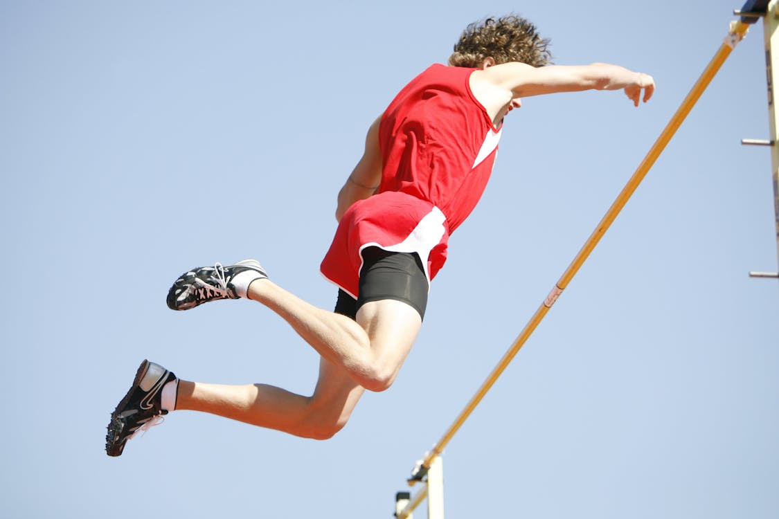 Free Athlete Jumping over the Rod Stock Photo