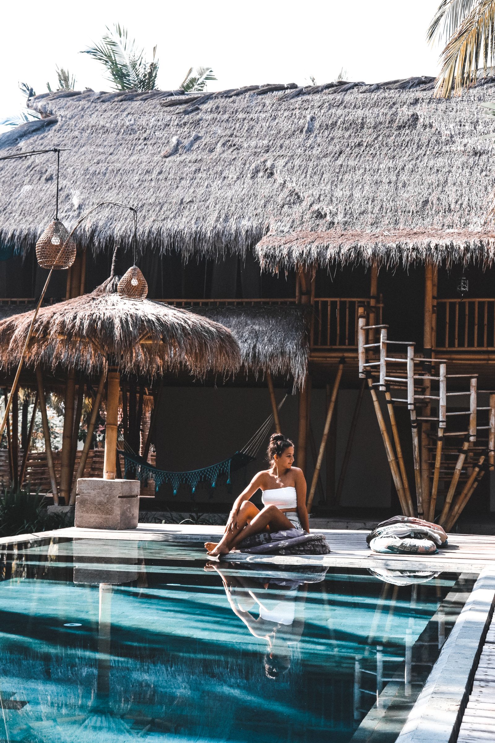 Guest relaxing by the pool terrace at Kestrel Harbor Inn