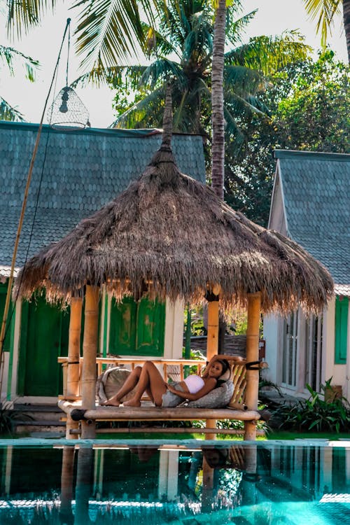 Free Woman Relaxing in a Hut Stock Photo