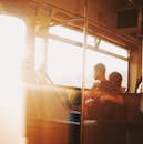 Man Sitting on Public Transportation Seat Beside Window