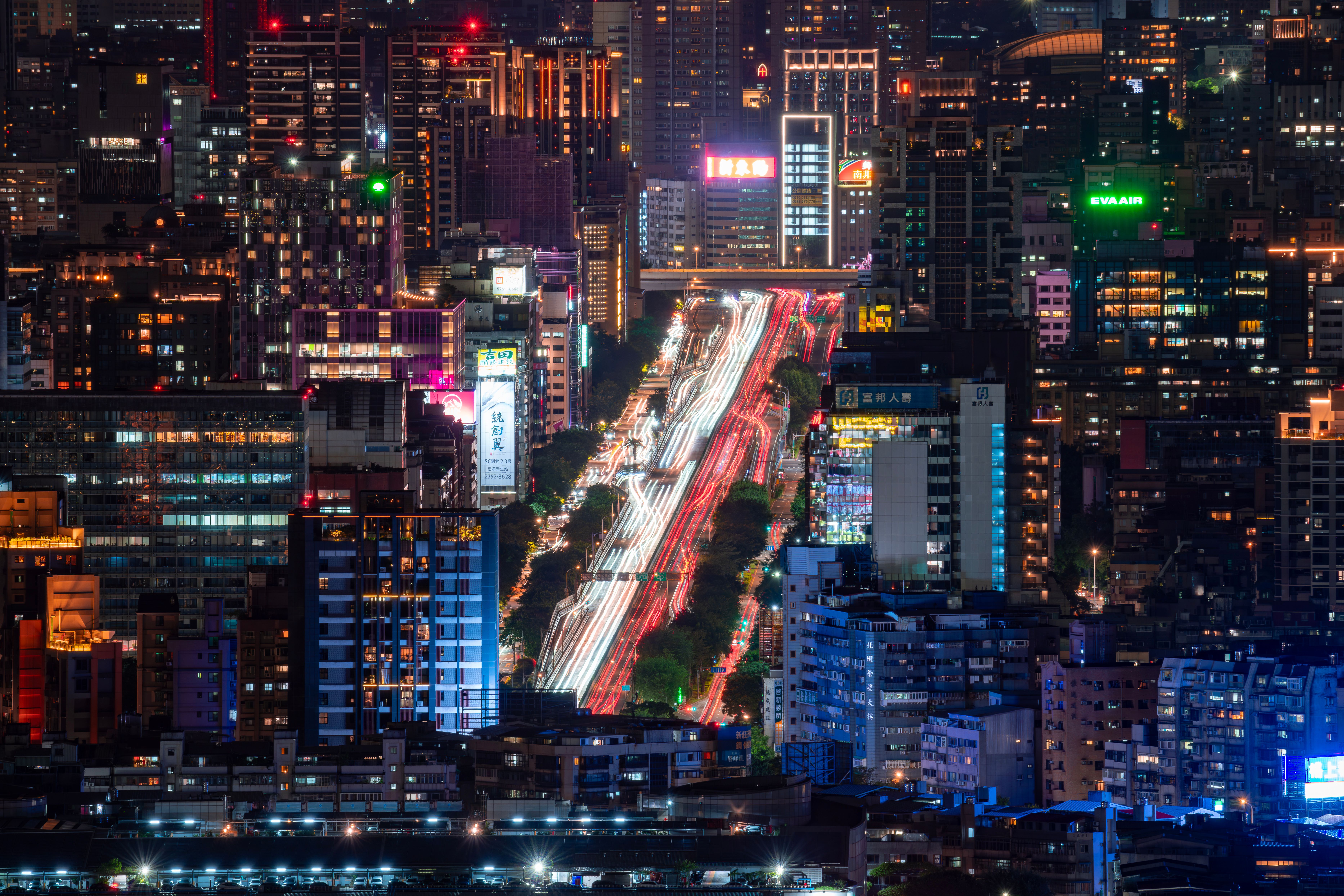 A breathtaking aerial view of Taipei at night showcasing bustling streets and illuminated skyscrapers.